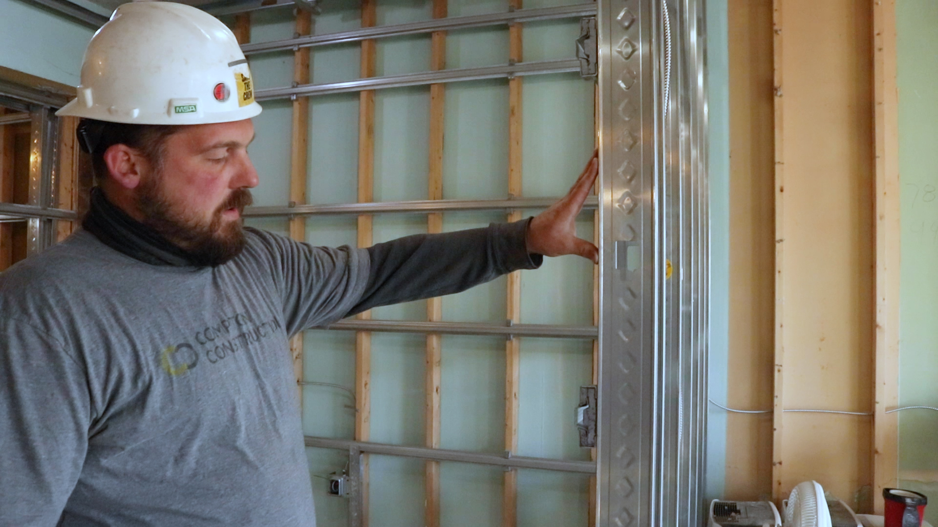 Don demonstrates the floating wall attachments that facilitate soundproofing